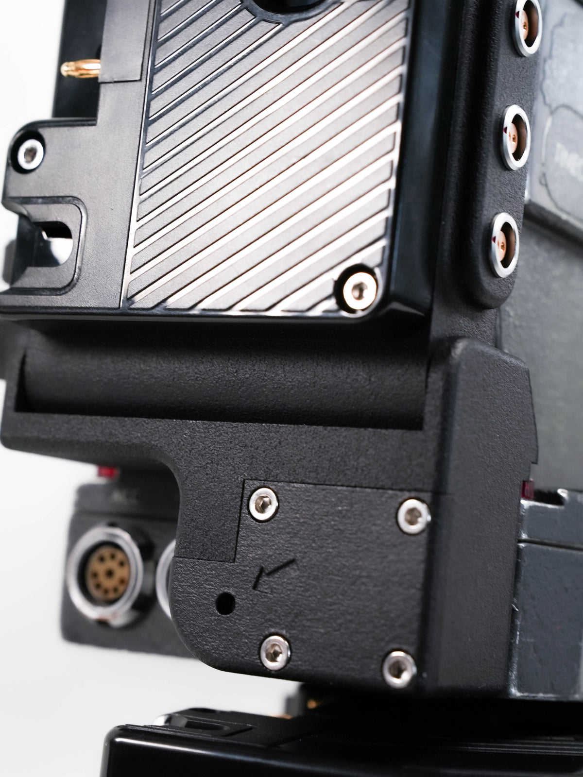 Arri SR3 battery adapter mounted on camera body powering vintage film camera