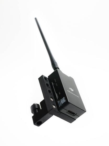 A black wireless transmitter receiver device for DJI Ronin 2 with an adjustable antenna and mounting bracket, shown on a plain white background.