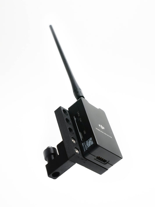 A black wireless transmitter receiver device for DJI Ronin 2 with an adjustable antenna and mounting bracket, shown on a plain white background.